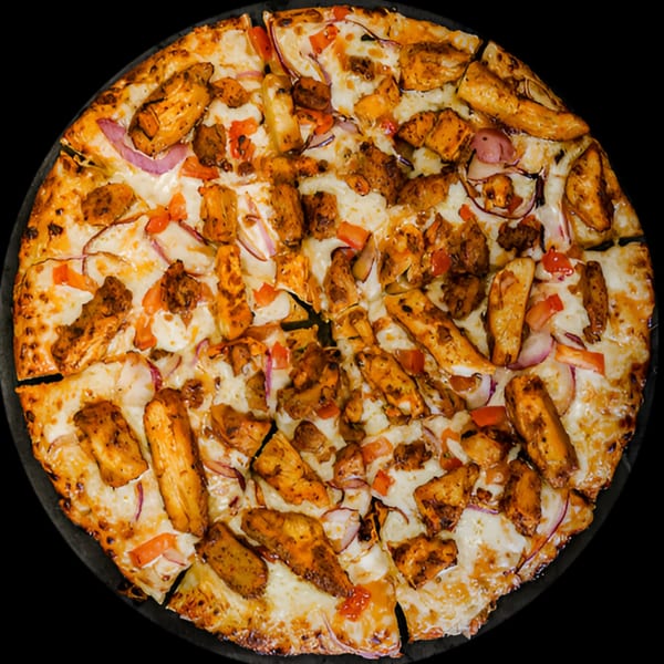 Masala Slice's chicken tikka pizza, topped with chicken, red onions, and bell peppers.